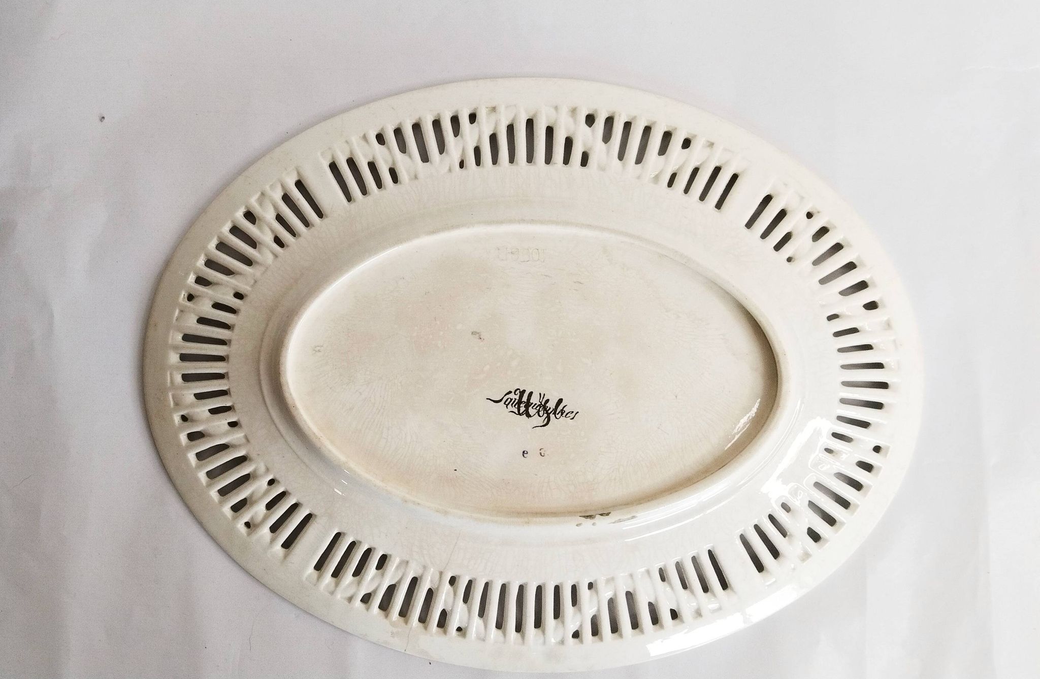 Oval dish in openwork earthenware from Sarreguemines, blue ribbon and fruit