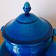 Blue ceramic soup tureen and crackled finish trivet.