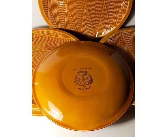 Ten plates in Salins slip with braided patterns 50s
