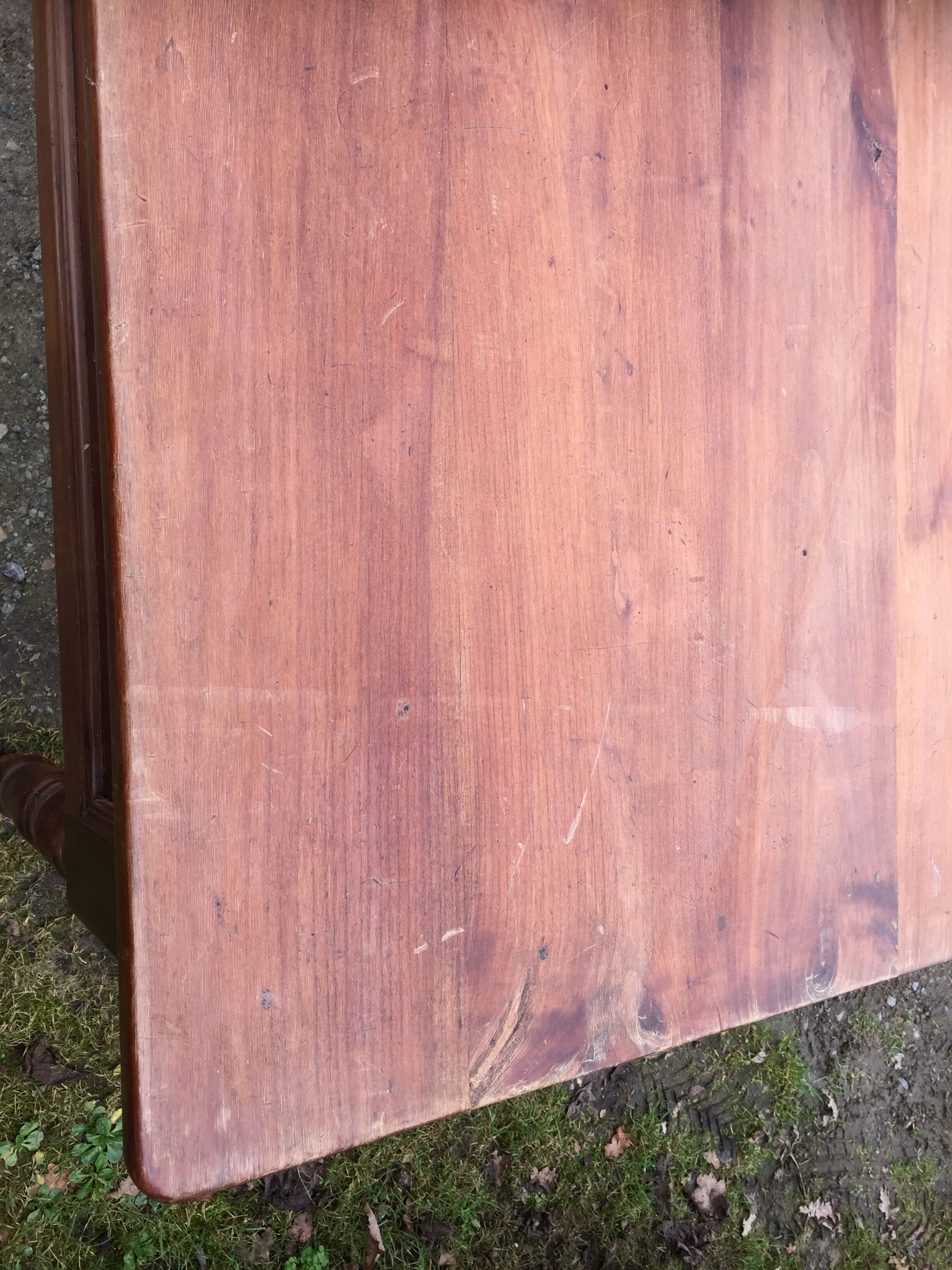 Old farmhouse table with cherry and chestnut panels with 3 drawers.