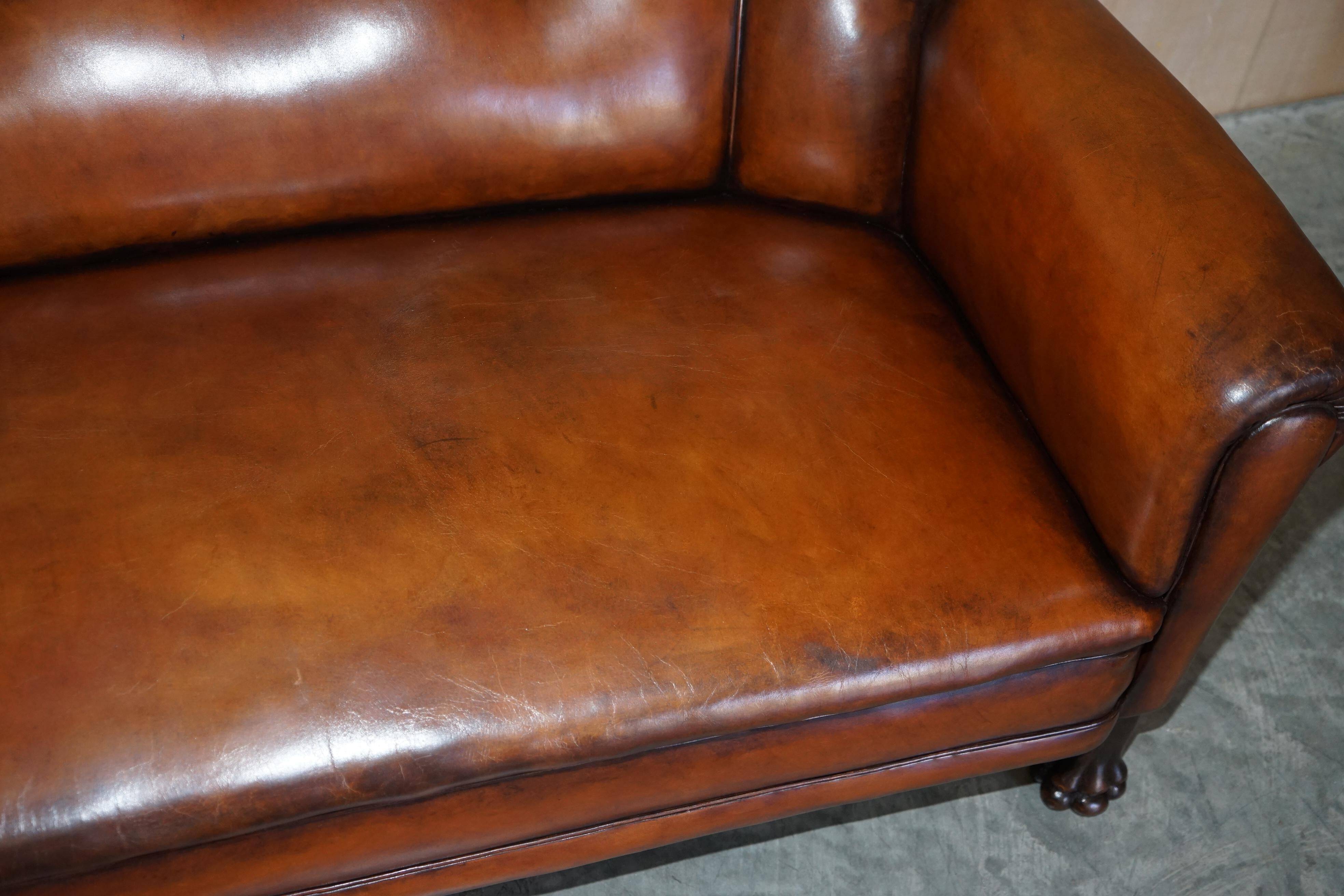 Victorian Chesterfield leather canapé with oak lion claw feet.