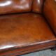 Victorian Chesterfield leather canapé with oak lion claw feet.