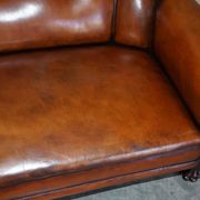 Victorian Chesterfield leather canapé with oak lion claw feet.