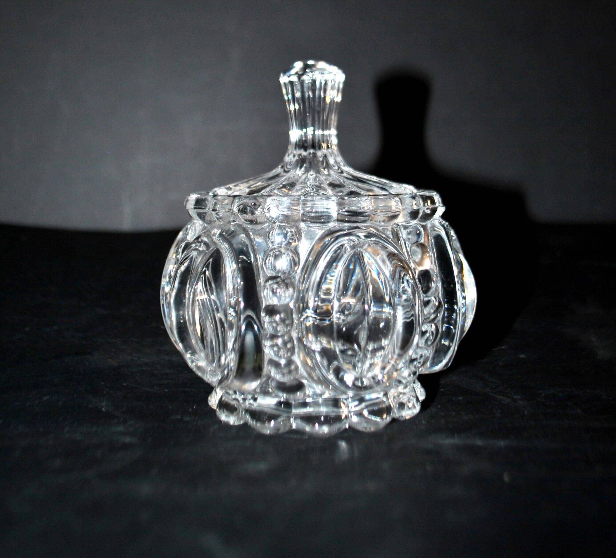 Thick moulded crystal sugar bowl with a beaded and medallion design.