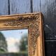 Miroir Empire en bois stuqué et doré, début XIXème siècle