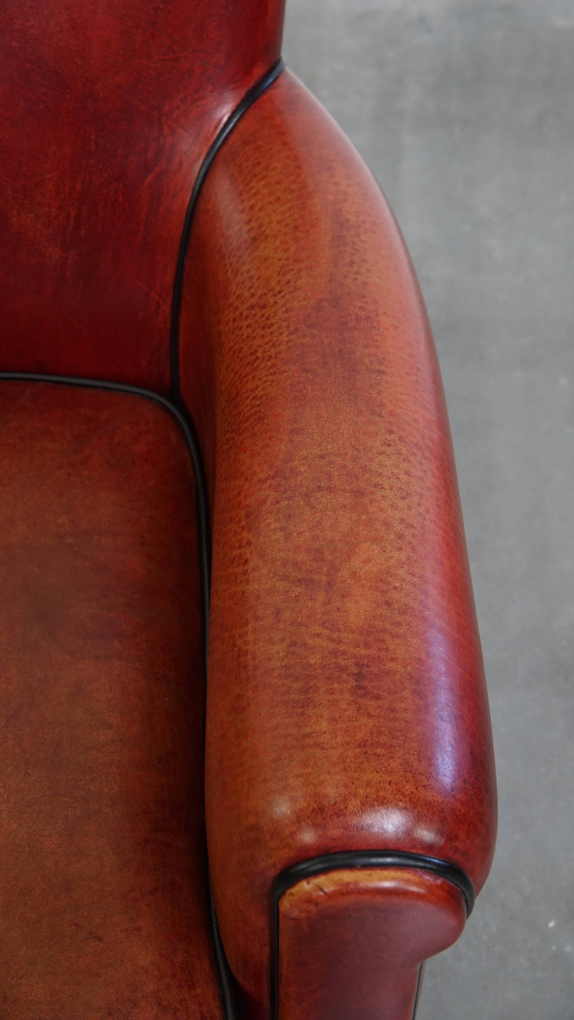 Armchair made of sheepskin leather in a red/brown color