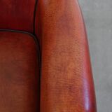 Armchair made of sheepskin leather in a red/brown color
