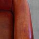 Armchair made of sheepskin leather in a red/brown color