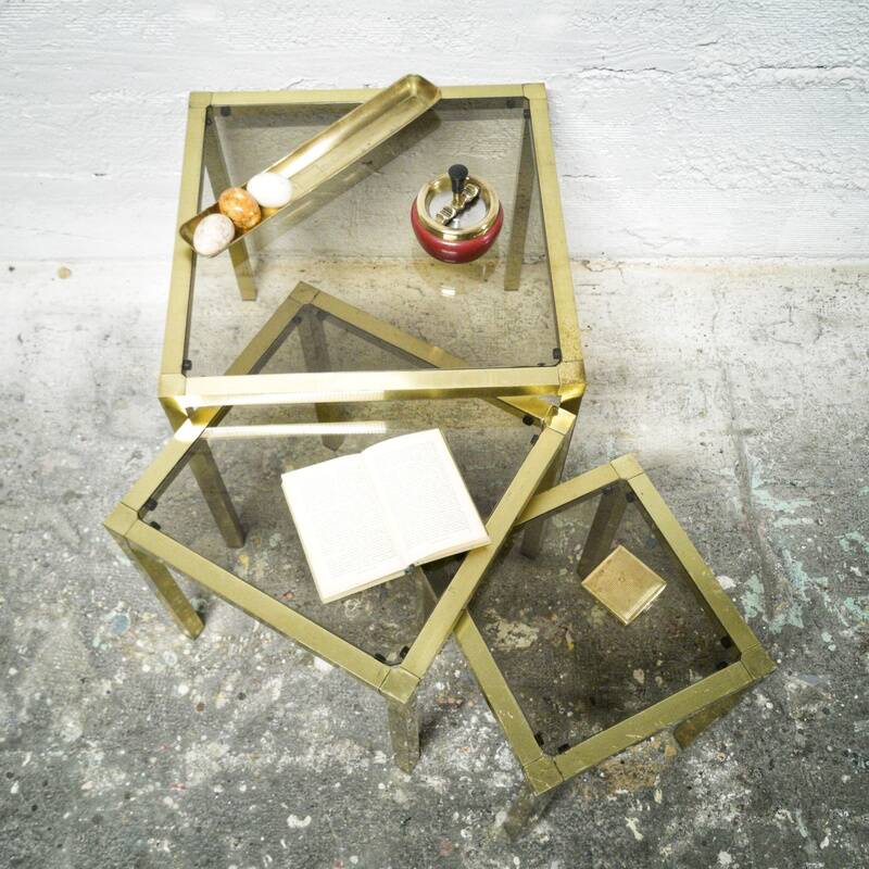 Trio of nesting tables in brass and smoked glass
