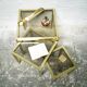 Trio of nesting tables in brass and smoked glass