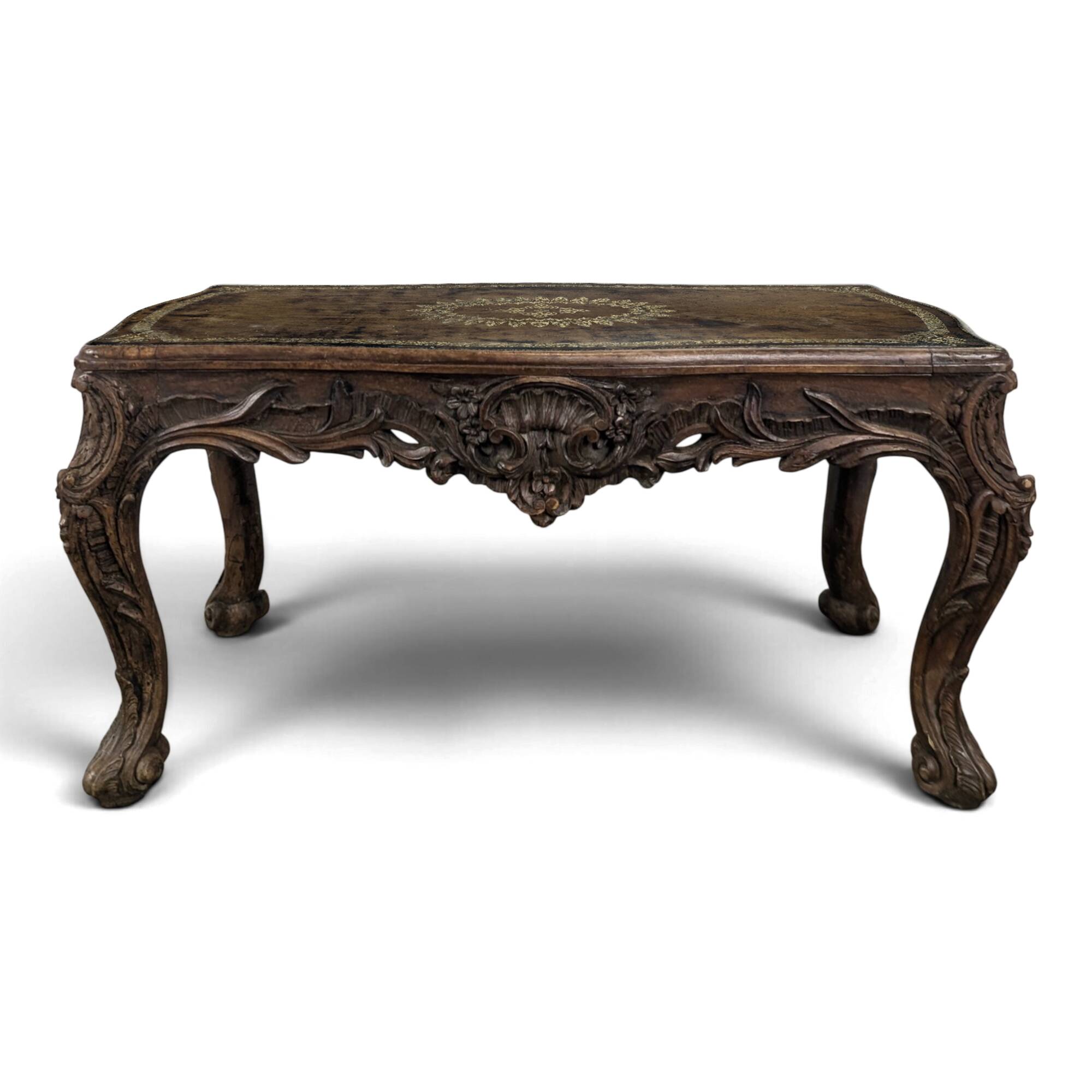 Louis XV coffee table in carved walnut with a gilded leather top.