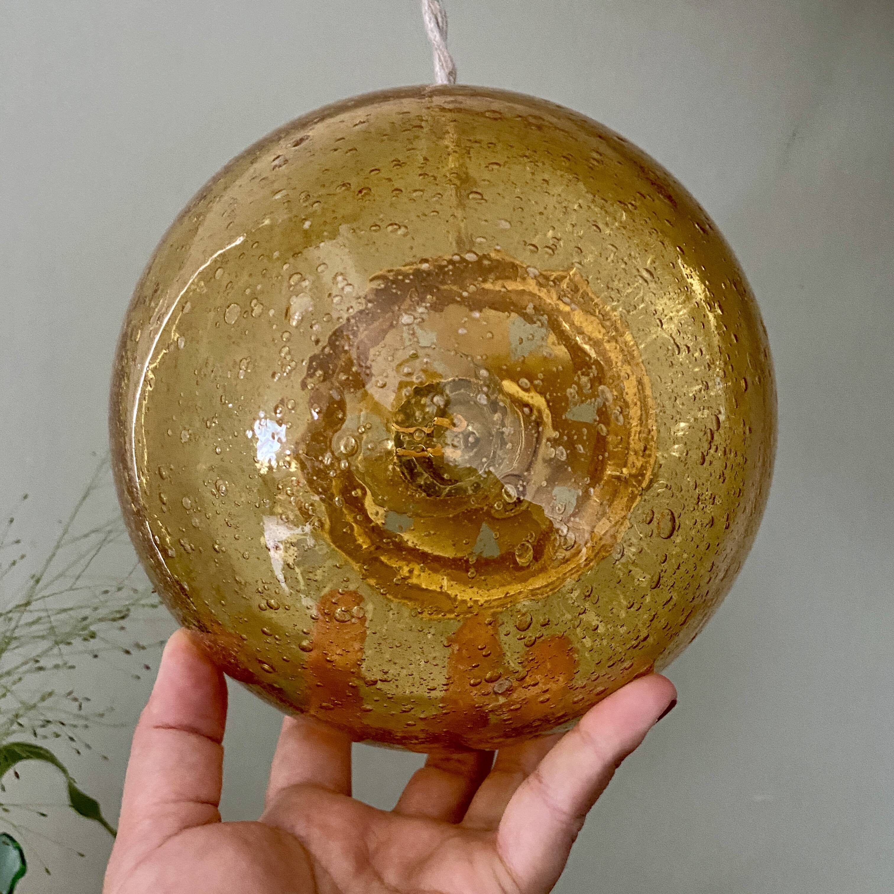 Vintage globe pendant light in bubbled amber glass