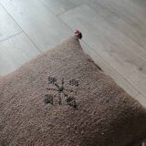 Moroccan brown cushion with cotton pompom