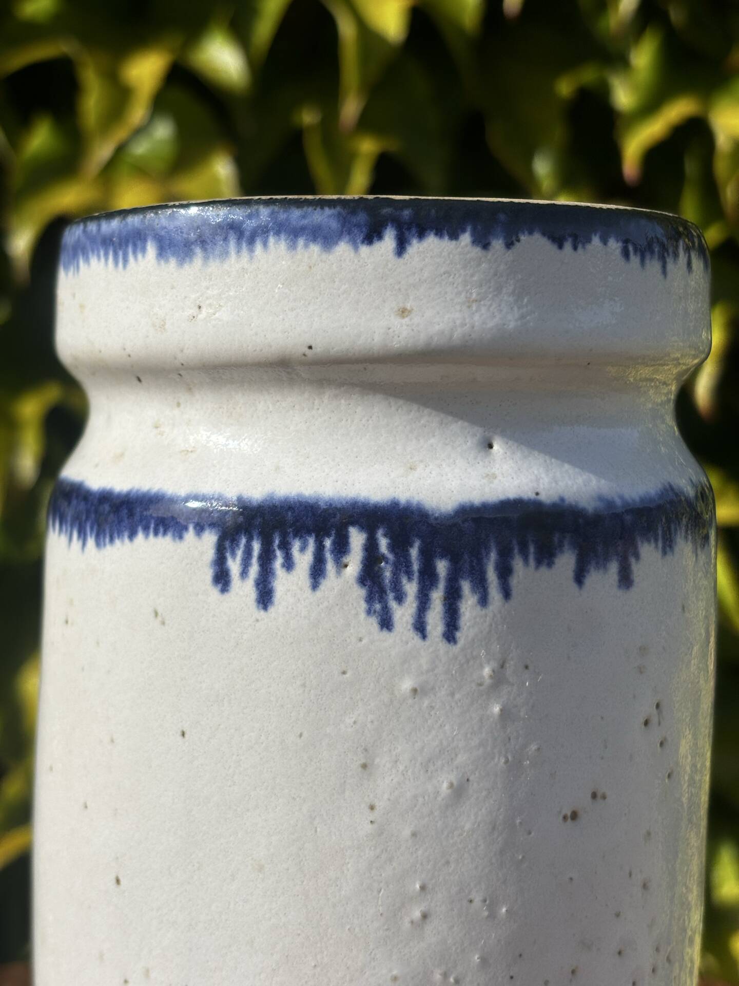 Pretty pot or vase in glazed stoneware with blue drip effect.