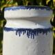 Pretty pot or vase in glazed stoneware with blue drip effect.