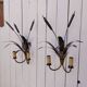 Brass wall lights with a bouquet of reeds by FlorArt.