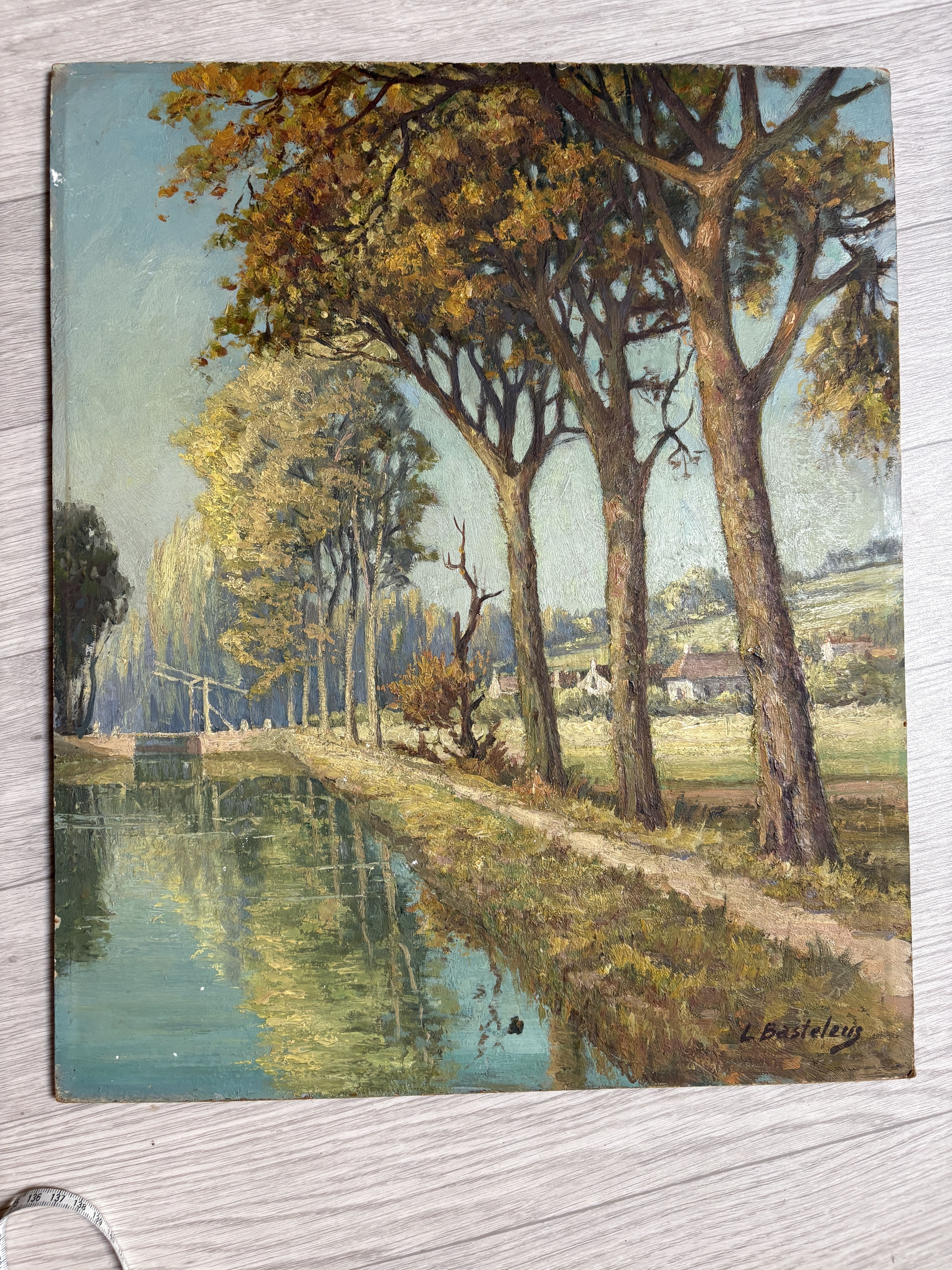 River landscape bordered by poplars, signed L. Basteleus, oil painting.