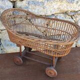 Old rattan cradle on wheels