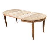 Large stripped solid oak dining table in Louis XVI style with 3 extensions.