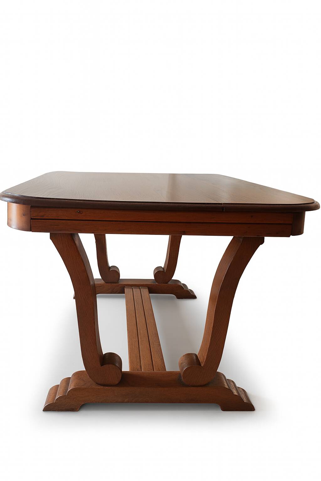 Solid wood dining table with a sculptural base.