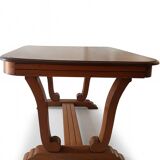 Solid wood dining table with a sculptural base.