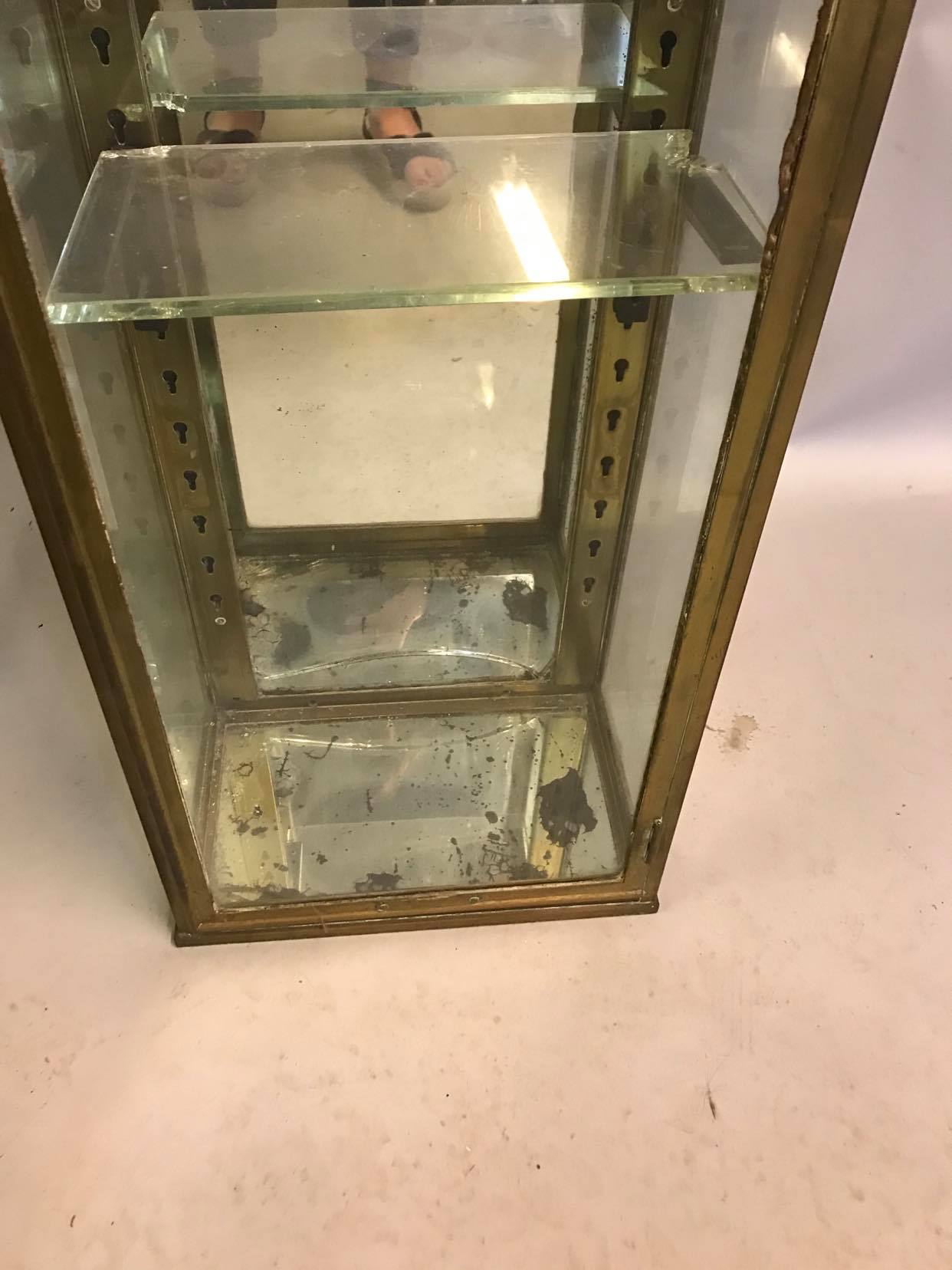 Old brass and mirror showcase