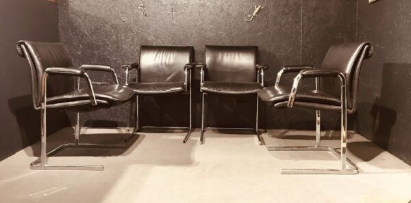 Pair of black leather Scandinavian armchairs