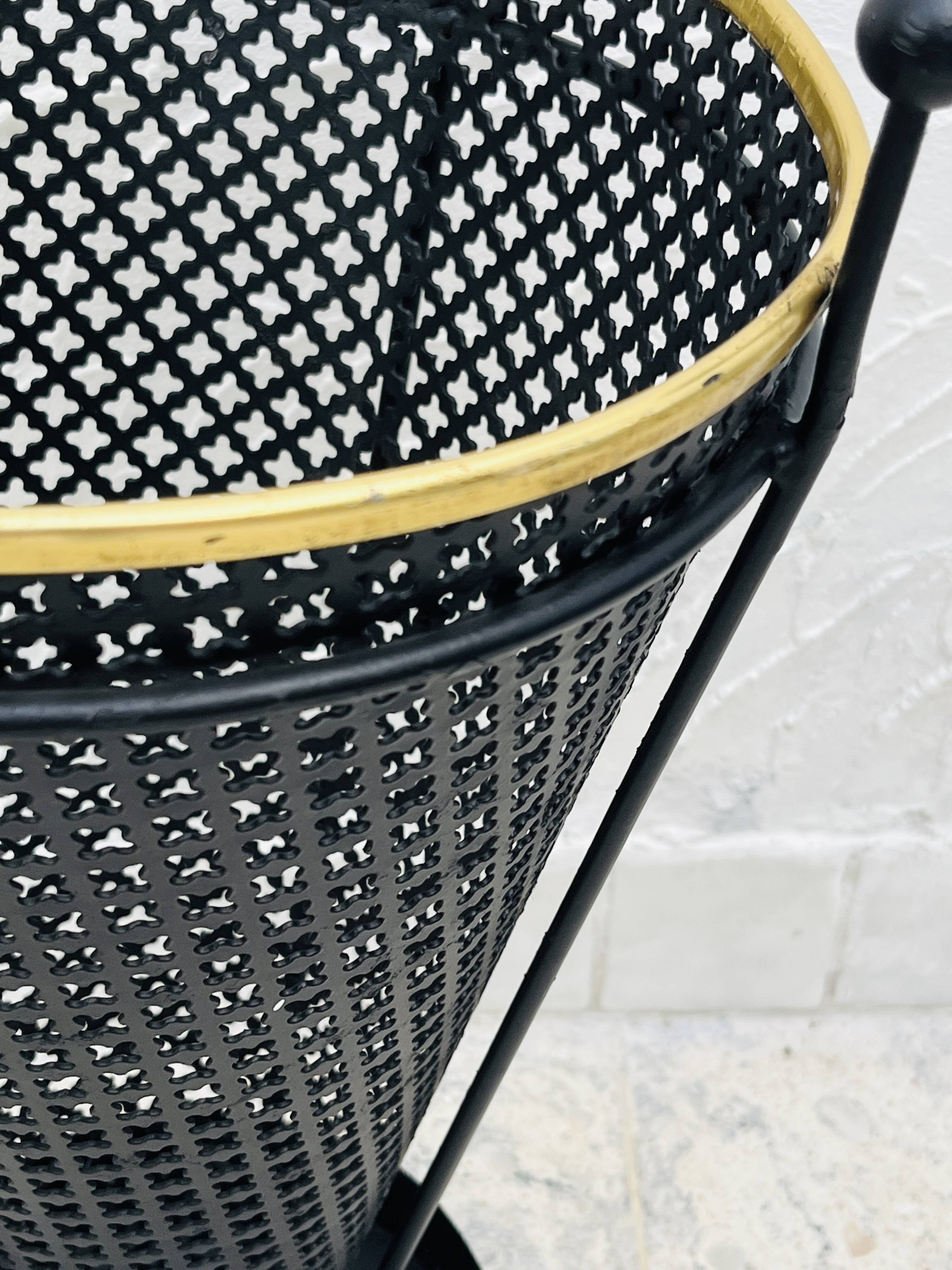 Vintage black perforated metal and brass umbrella stand