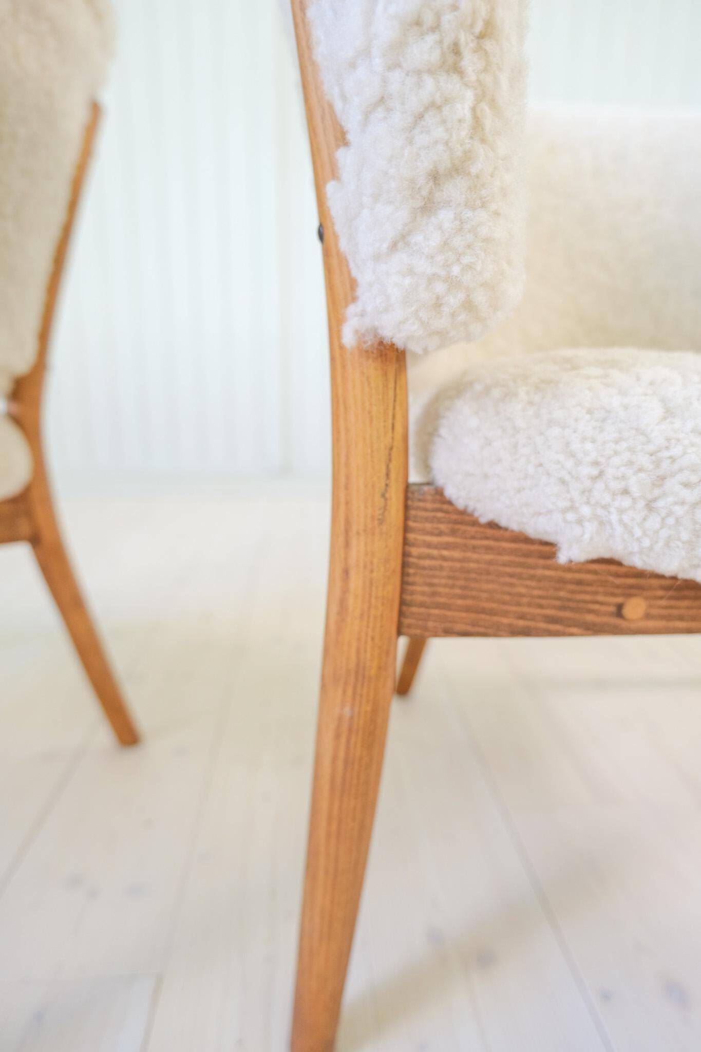 Mid-century lounge chairs in sheepskin/shearling and stained wood, Sweden, 1962.