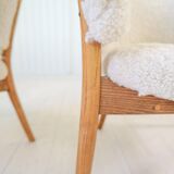Mid-century lounge chairs in sheepskin/shearling and stained wood, Sweden, 1962.