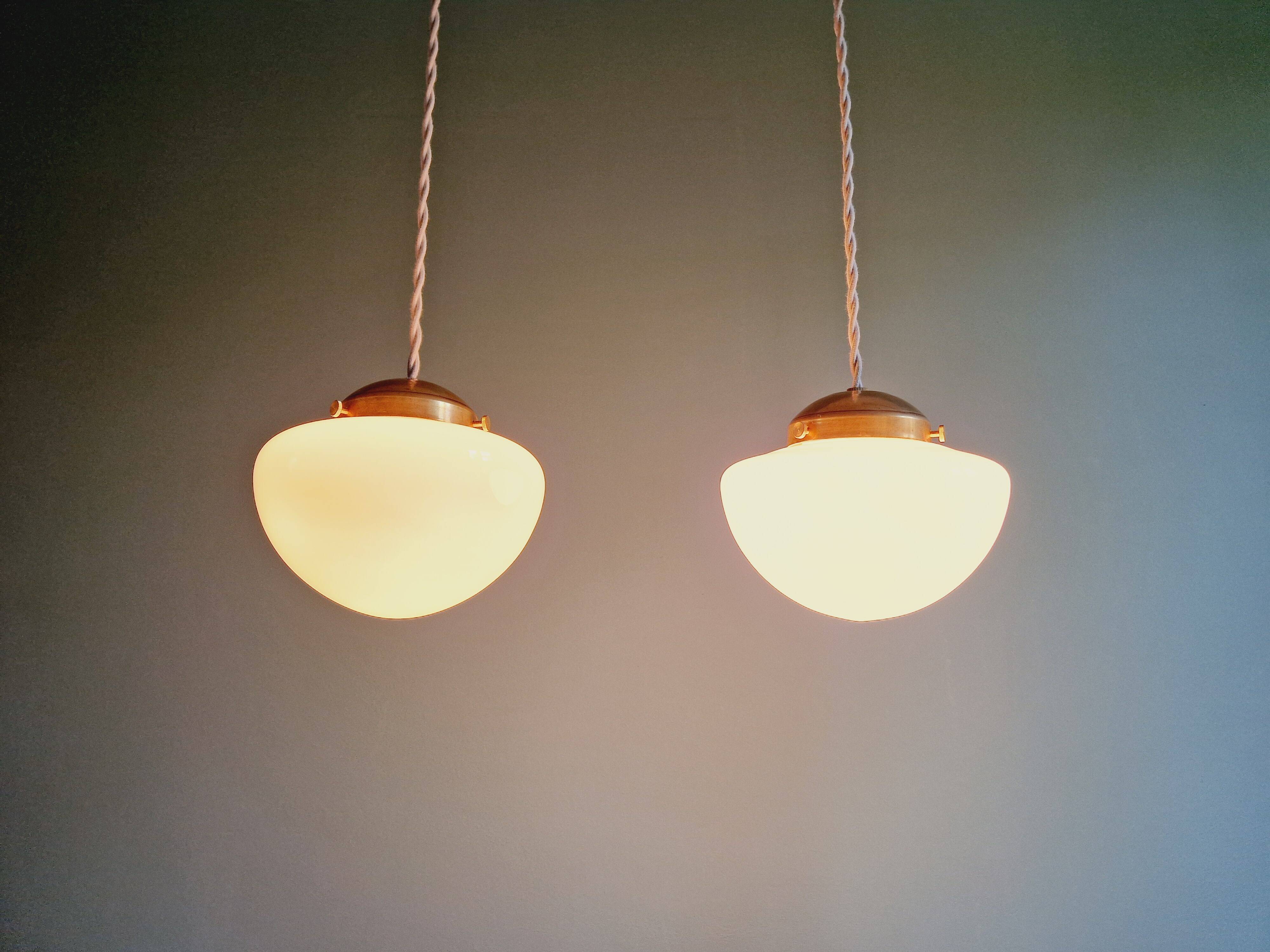 Duo of Art Deco suspensions in white opaline, 1920s-30s