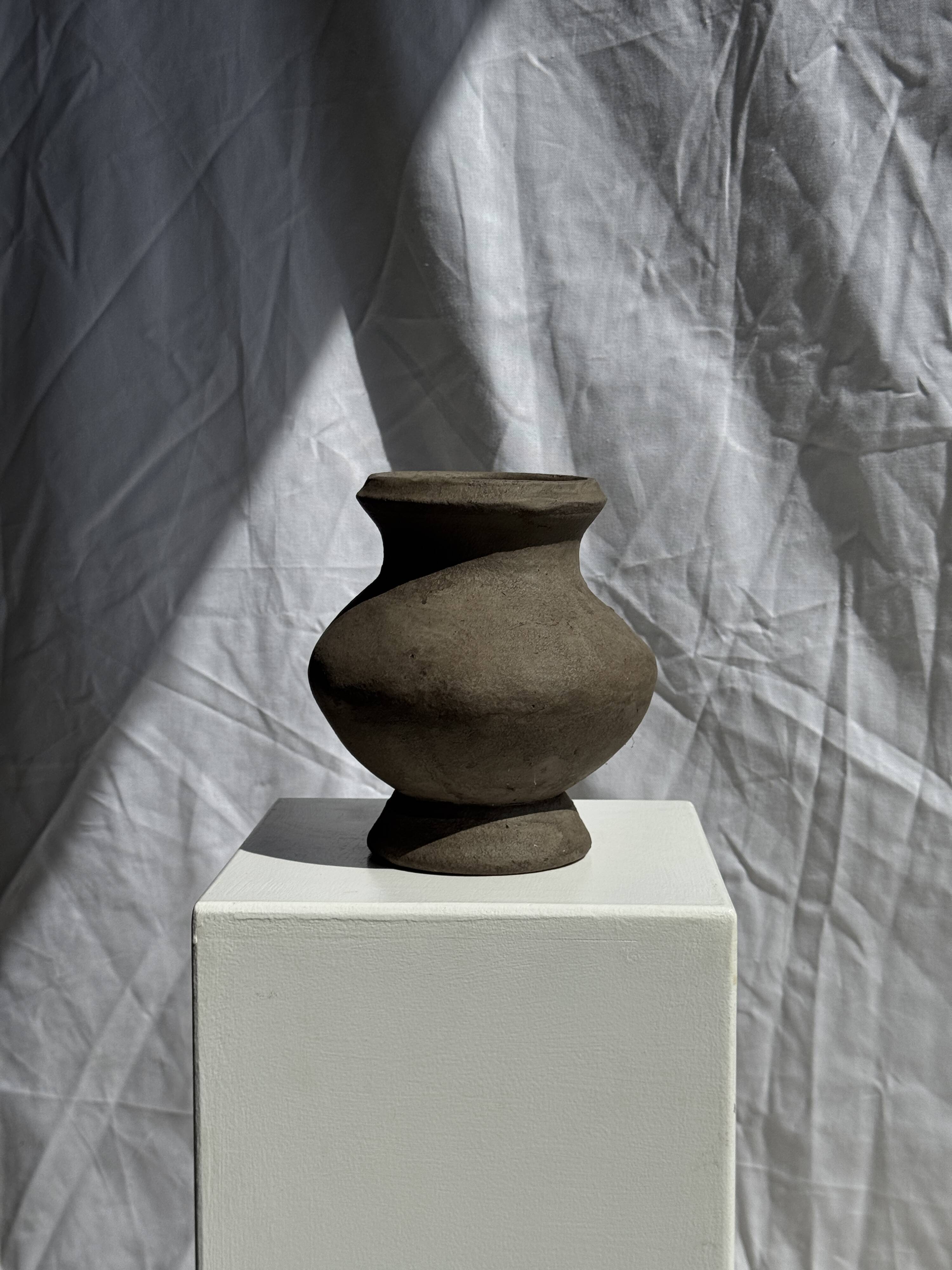 Small brutalist handcrafted terracotta vase with a pedestal, Indonesian, H19 D17.