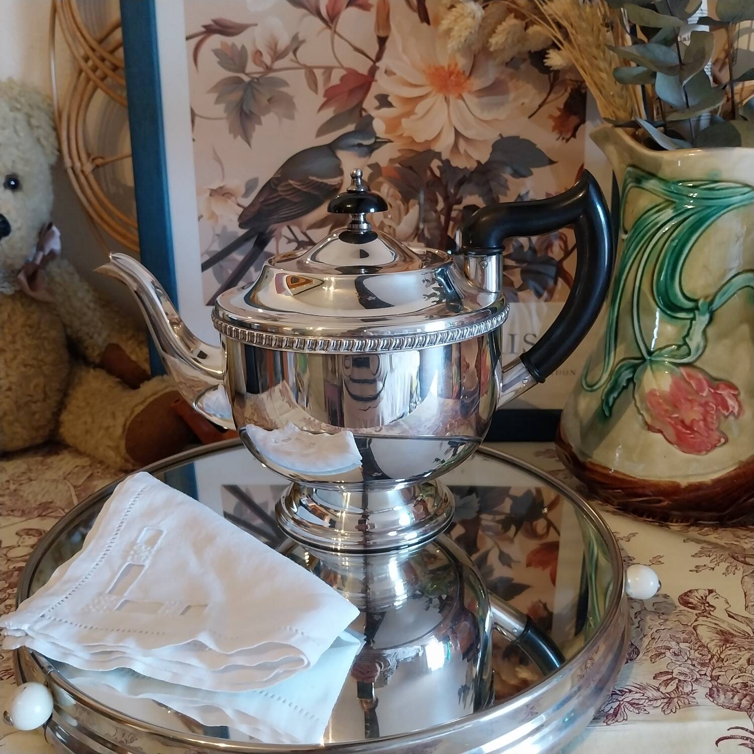 Old English teapot in silver-plated metal and Bakelite.