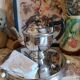 Old English teapot in silver-plated metal and Bakelite.
