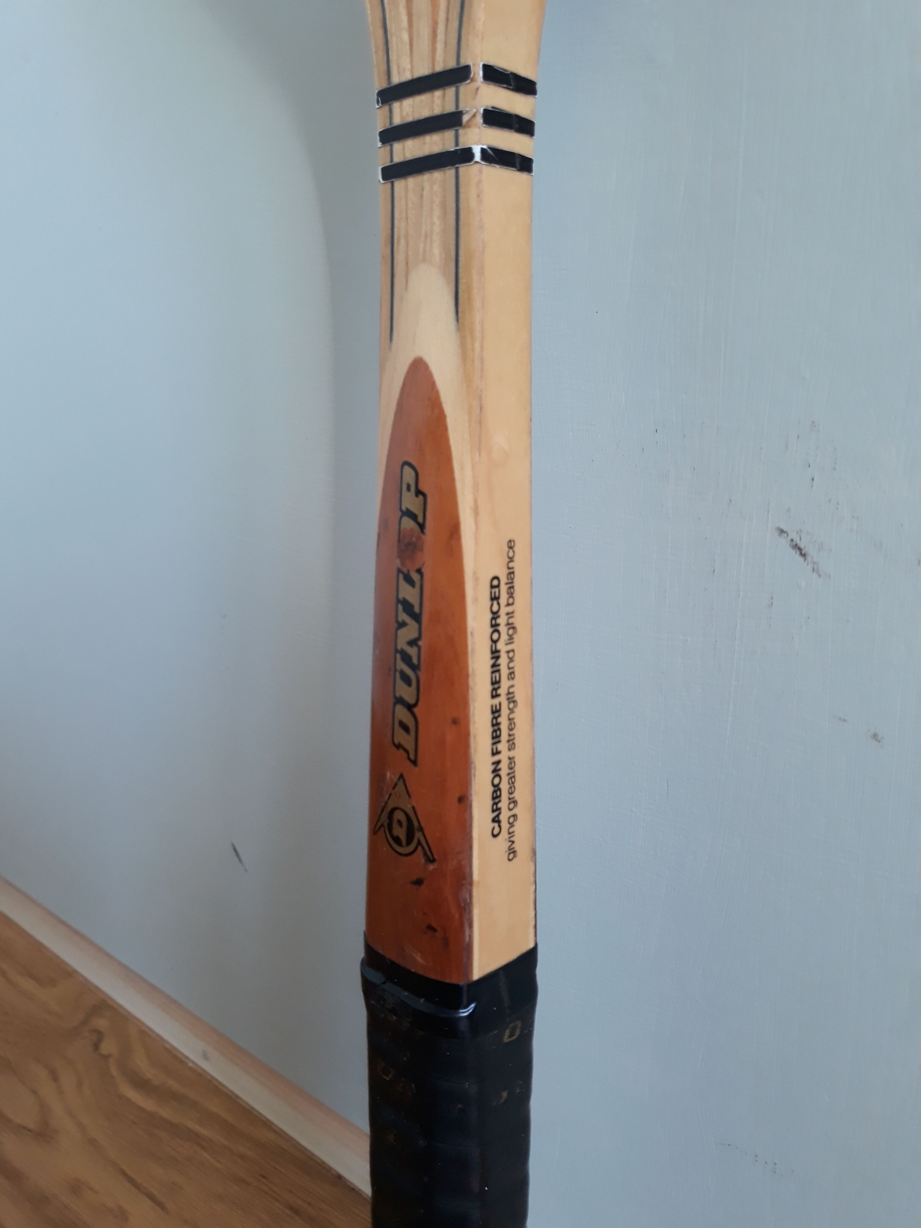 Wooden Dunlop tennis racket with its cover