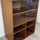 Teak bookshelf, sliding display + open storage, 60s/70s