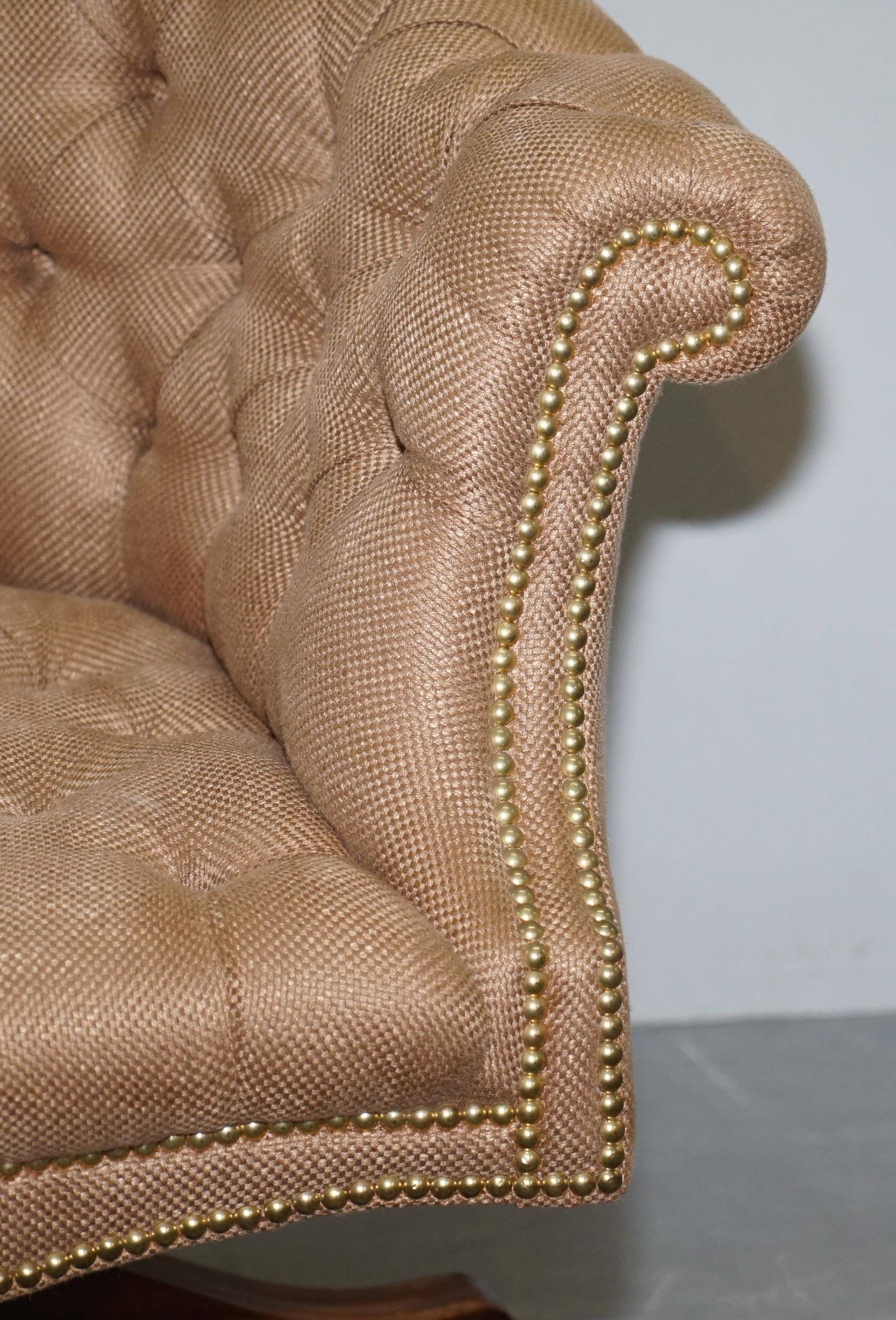 Chesterfield armchair in hardwood, leather, and woven linen.