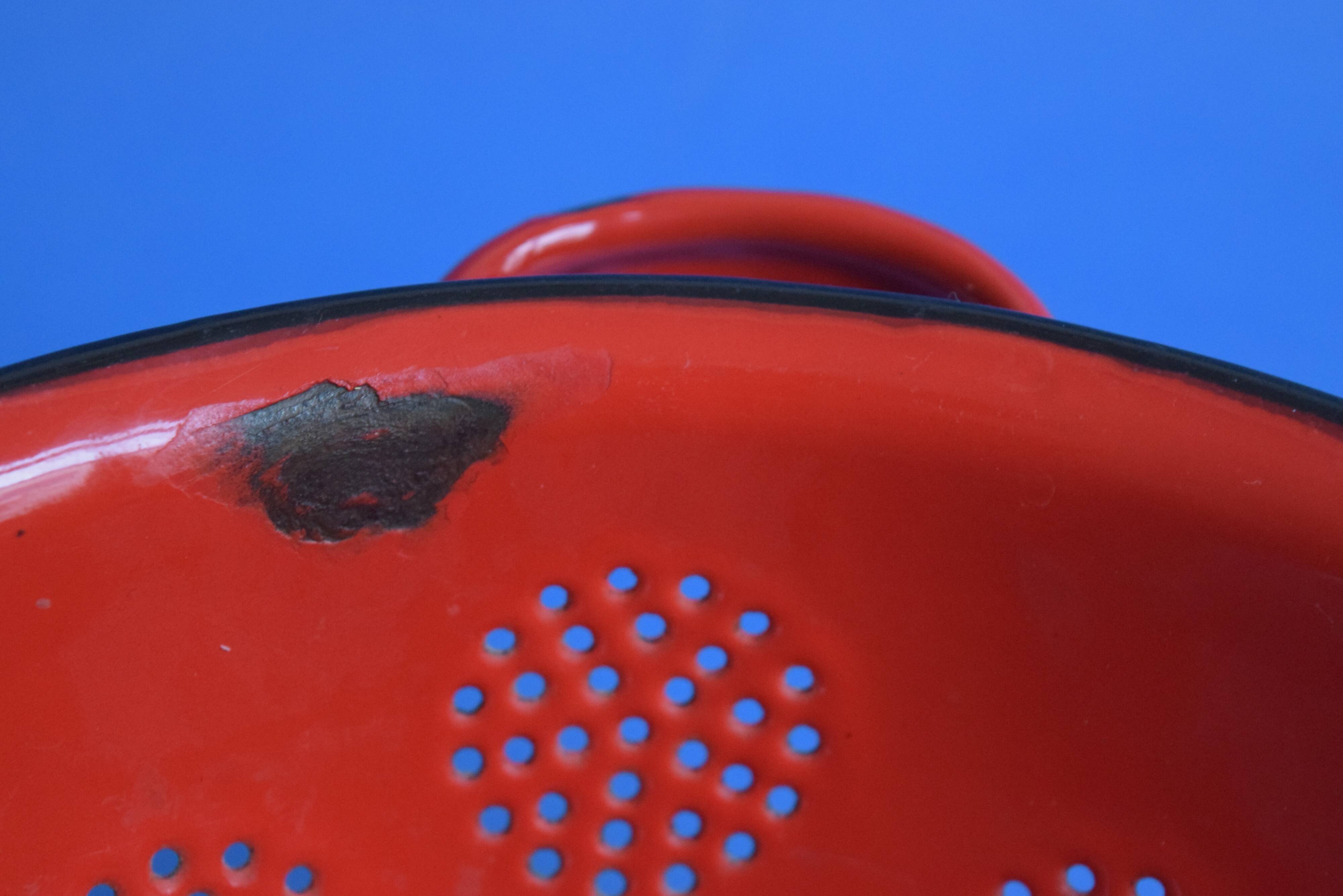 Vintage red enameled sheet metal colander