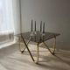 Coffee table with smoked glass and curved metal base