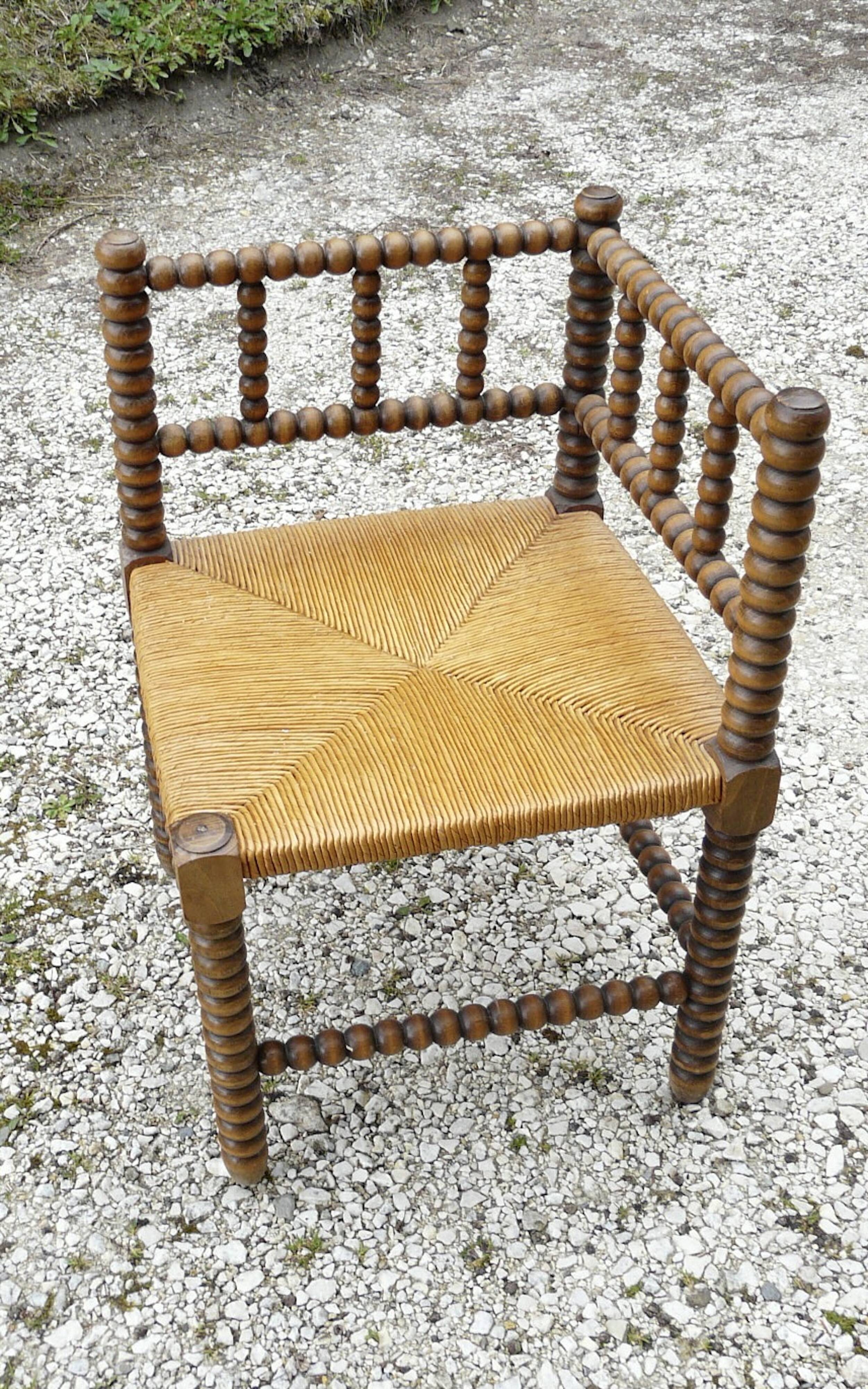 Turned wood straw corner armchair