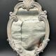 Wall mirror – sculpted silver frame, with a golden reflection and a touch of green –