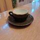 Green and gold coffee cups and sub-cups