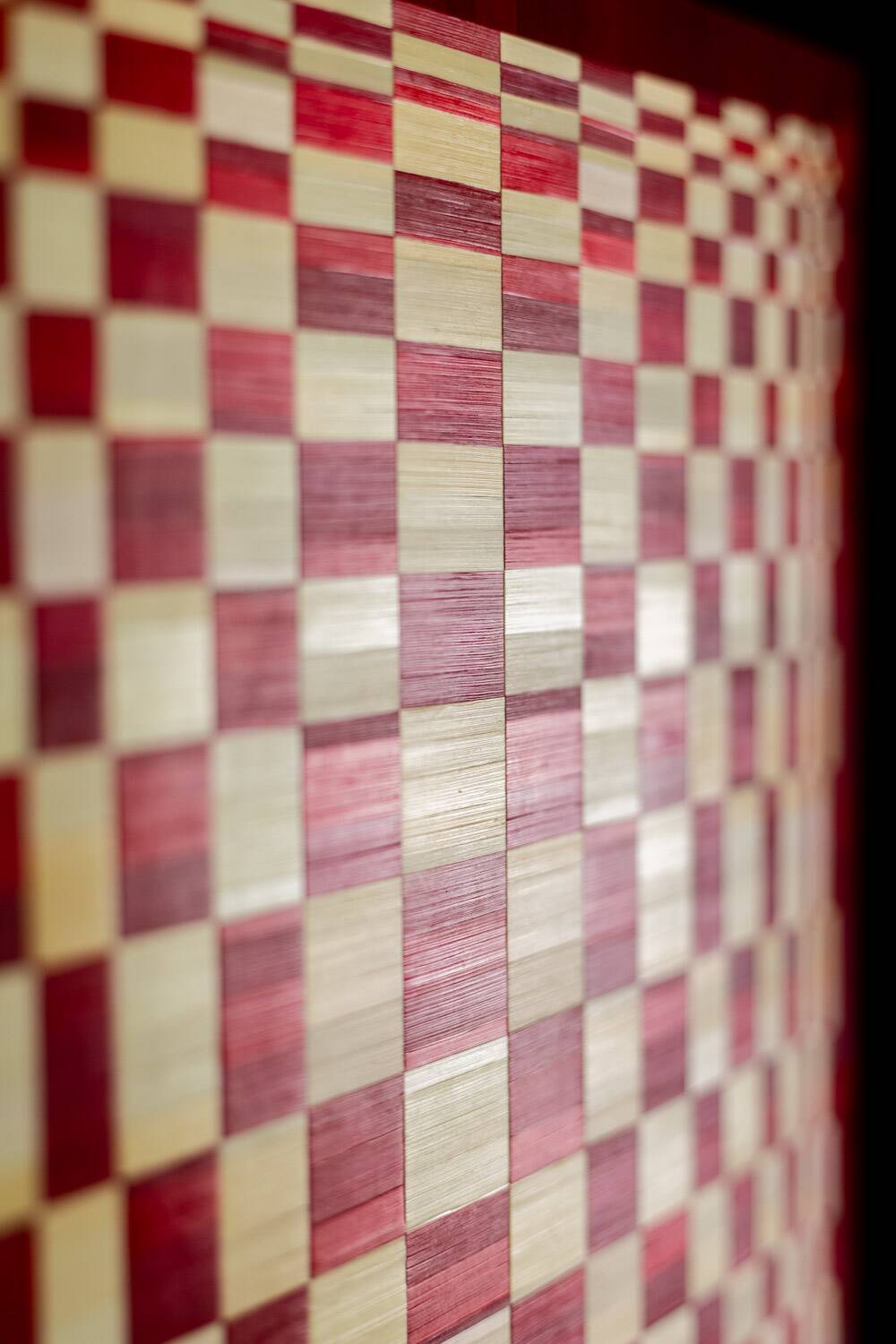 Pair of panels in red and gold straw marquetry. Contemporary.