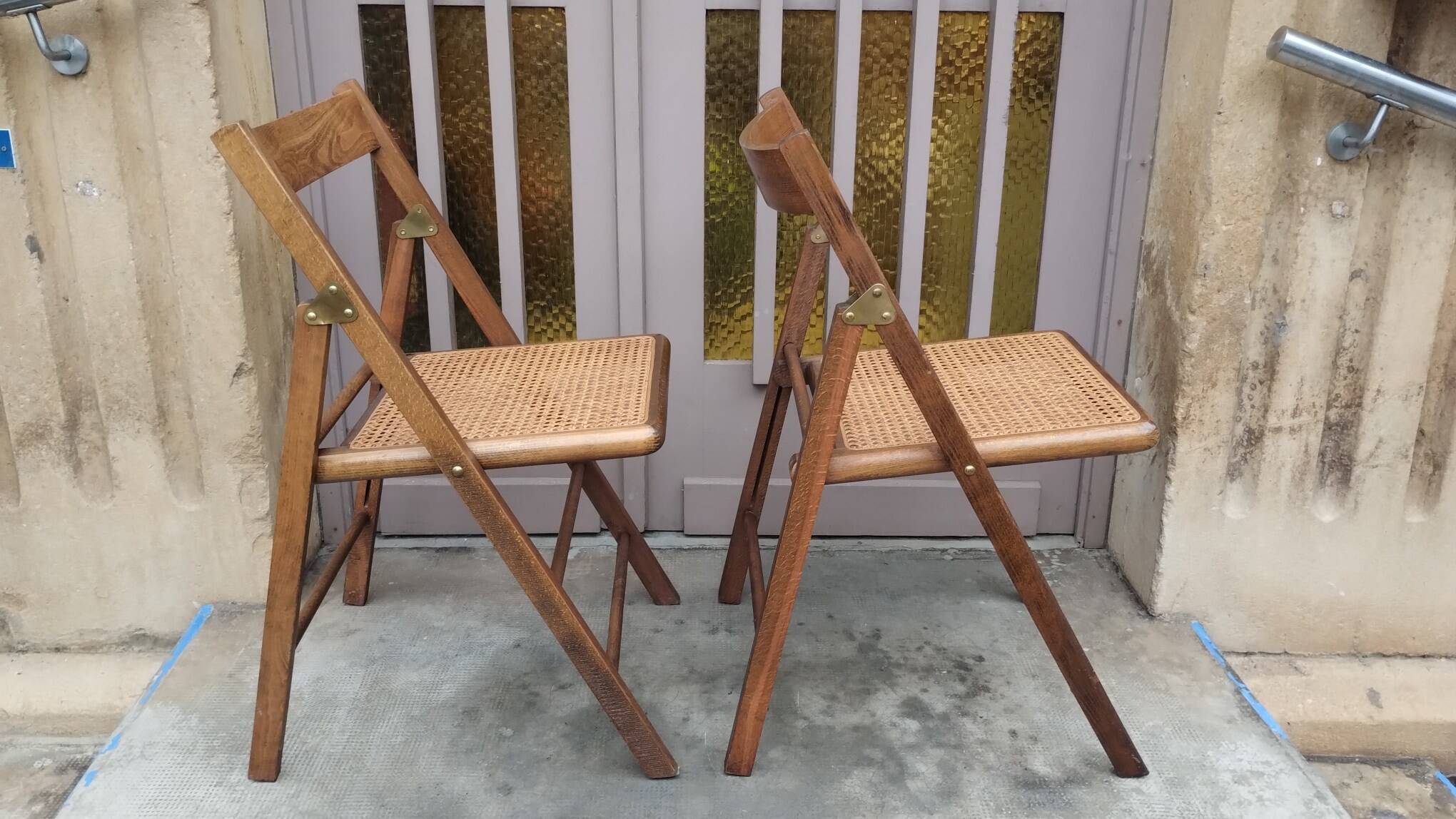 Pair of vintage wooden and cane folding chairs