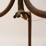 Wrought iron tripod floor lamp decorated with stylized animal heads