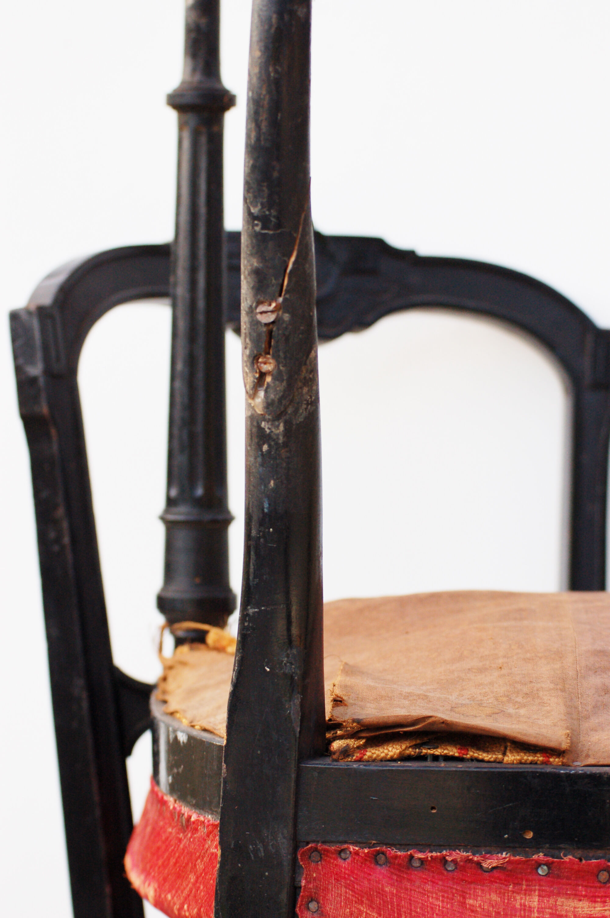 Pair of old black wooden chairs and Red seat.