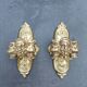 Pair of bronze wall sconces with mask, signed L. Pinet, Art Nouveau period.