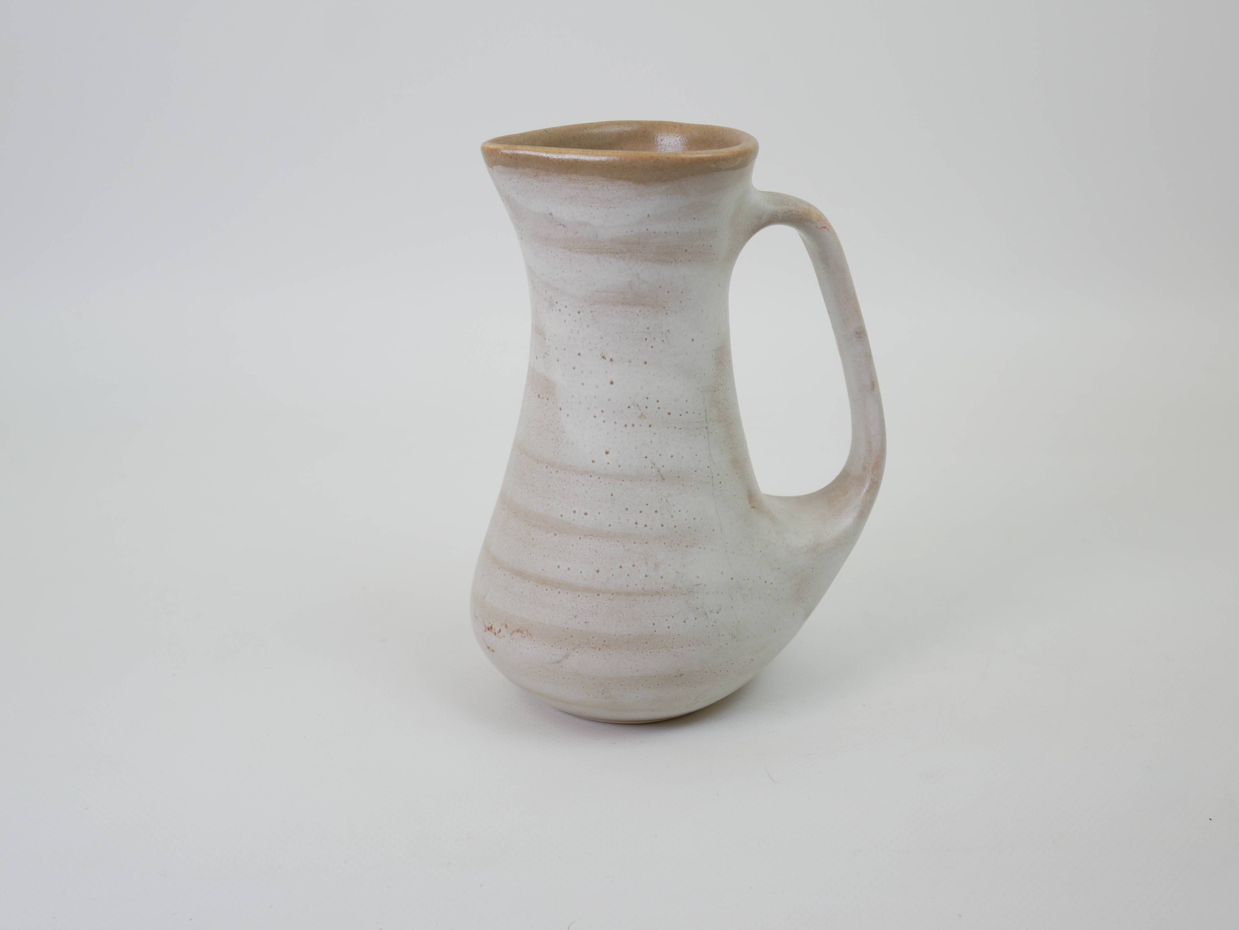 Signed white beige ceramic pitcher