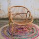 Fauteuil vintage « coquille » en rotin