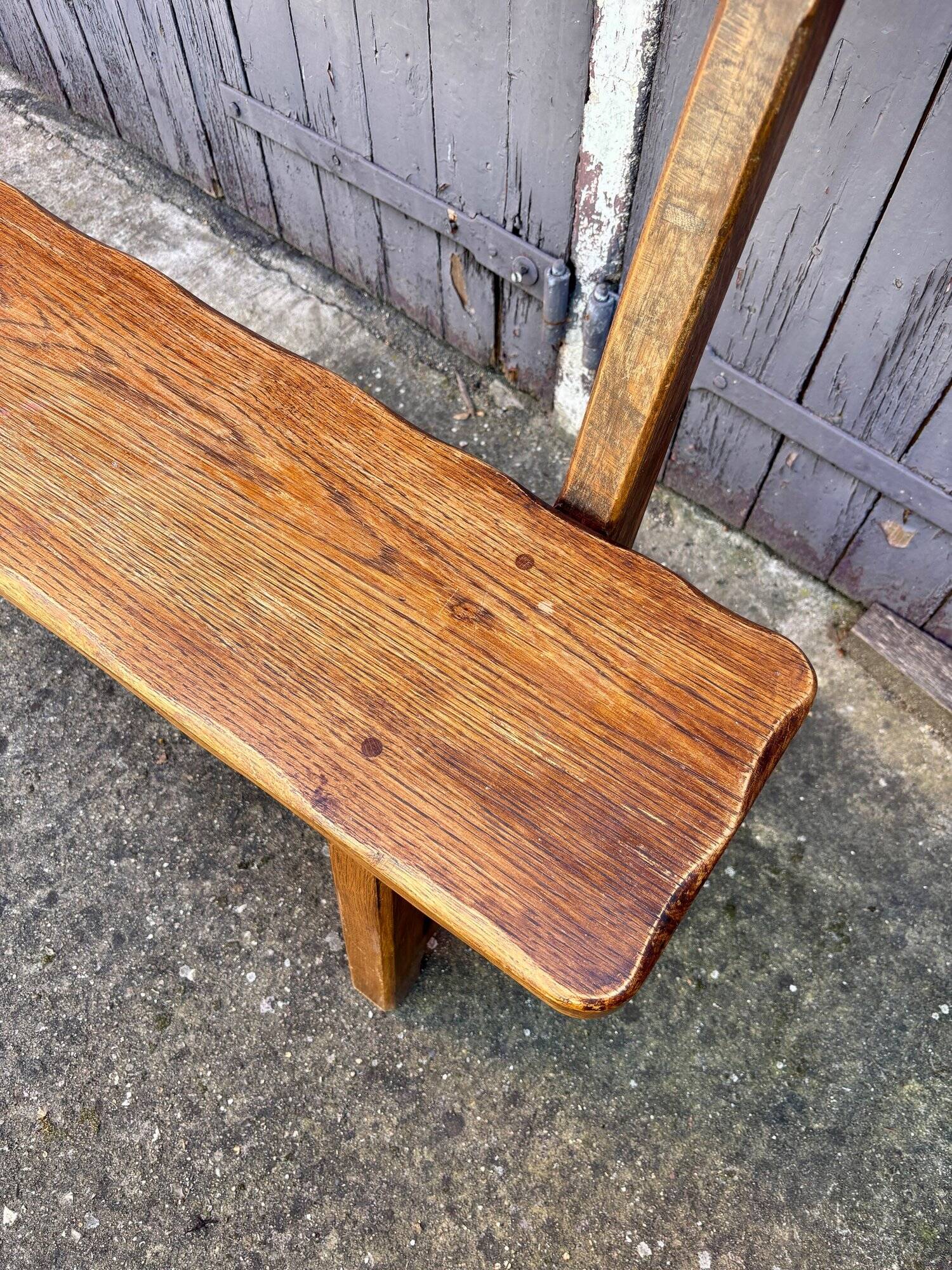 Brutalist bench with dark wood back